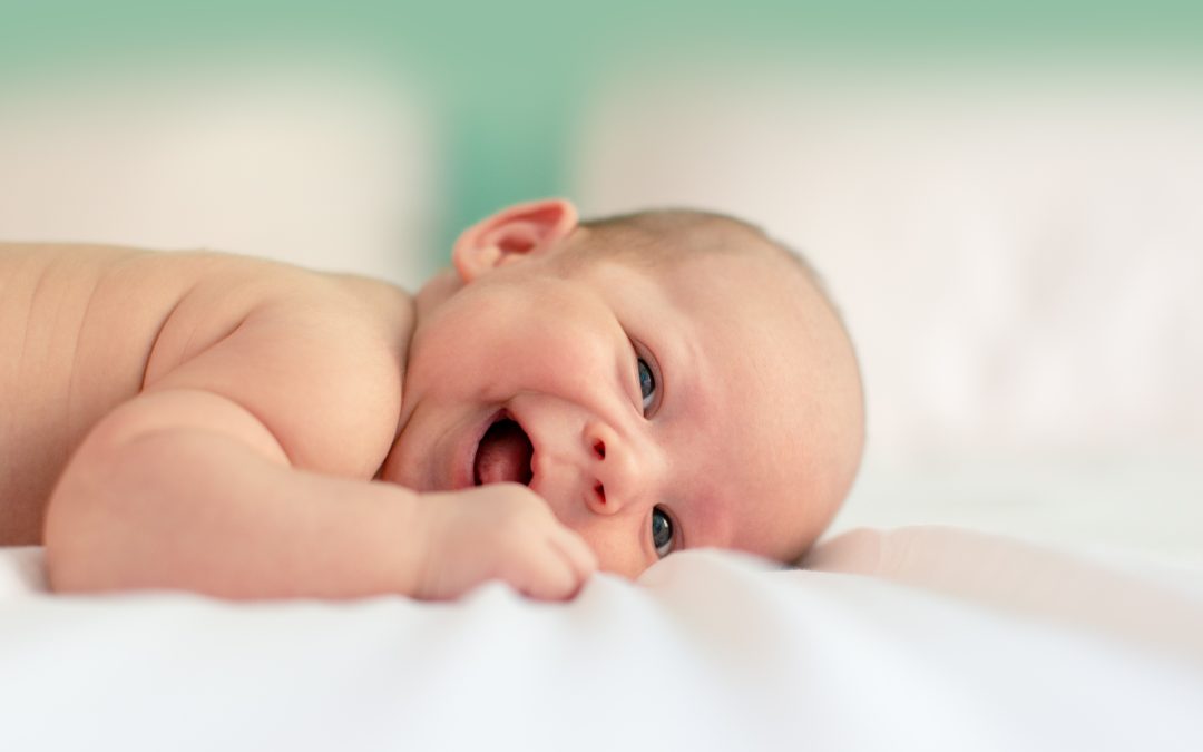Smiling baby on a blanket